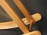 a wooden rocking chair on a black background