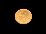 l'image d'une pièce d'or sur fond noir, avec la lune en arrière-plan