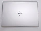 the back of a laptop computer sitting on top of a white table