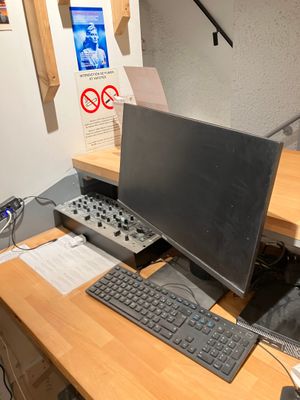 a desk with a computer and a keyboard on it