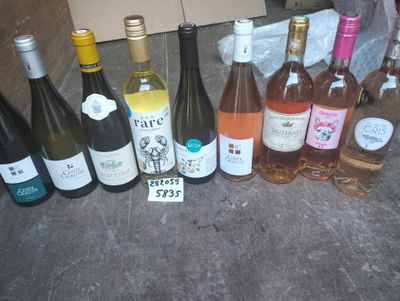 several bottles of wine are lined up on a table