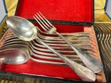 silverware in a red case on a red mat with a fork and spoon