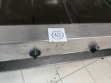 a sign on the side of a conveyor belt in a kitchen