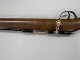 a close up of a rifle on a white surface