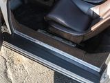 a car door open with the driver ' s seat in it