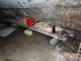 a table with a bottle of wine on it in a cave