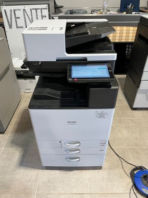 a multi - function printer sitting on top of a cabinet