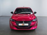 the front view of a red car in a showroom