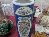 many vases on a table with a red table cloth