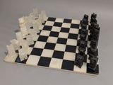 a black and white chess board with chess pieces on it