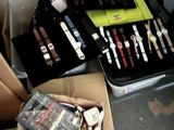 a box full of makeup brushes and other items on the floor