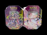 two tins of pokemon trading cards are shown on a black background