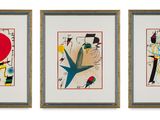 three framed paintings of different shapes and sizes on a white wall