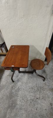 a small wooden table and two chairs in a room