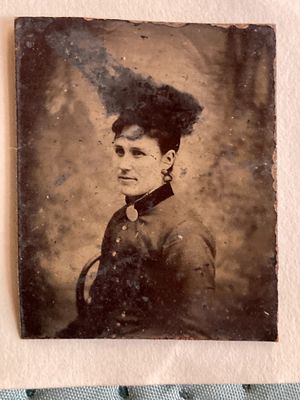 an old photo of a woman with a feather on her head