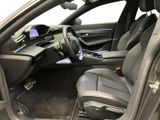 the interior of a car with the door open and the driver ' s seat down