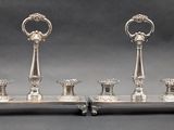 a pair of silver candlesticks on a stand