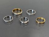 four different types of rings on a black surface