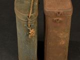 two old suitcases sitting next to each other on a black surface