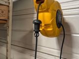 a yellow blower attached to a wall in a garage