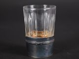 a shot glass with a liquid in it on a black surface