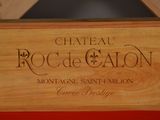 a wooden box with a sign on it that says chateau roc de calon
