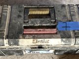 a close up of a tool box with a blue tag on it