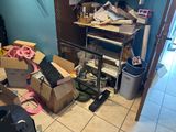 a room with a lot of clutter and boxes on the floor