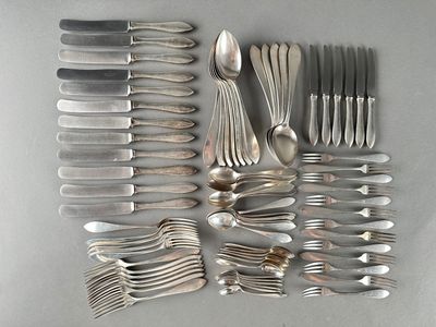 a lot of silver spoons and forks laid out on a table