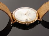 a close up of a wrist watch with a leather band