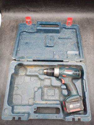 a drill in a case with a tool inside of it