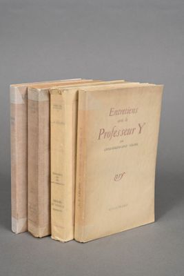 three books sitting on top of each other on a gray surface