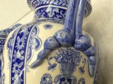 a large blue and white vase sitting on the floor