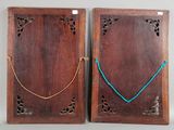 two wooden plaques with blue string and a wooden plaque with a blue string