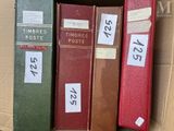 three books in a box with labels on them