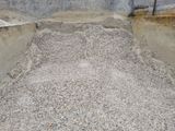 a large pile of gravel in the middle of a concrete wall