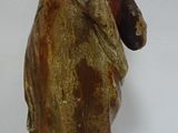 statue of a woman with a hat on her head and a bag on her back