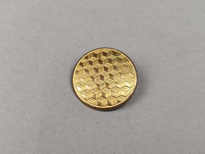 a close up of a gold coin on a white surface