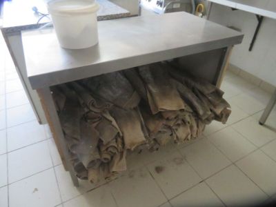a metal table with a bunch of bags on top of it