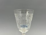 a glass with a label on it sitting on a table
