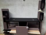 a computer desk with a laptop on top of it