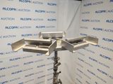 an image of a metal object on a stand in front of a wall