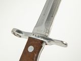 a close up of a knife with a wooden handle