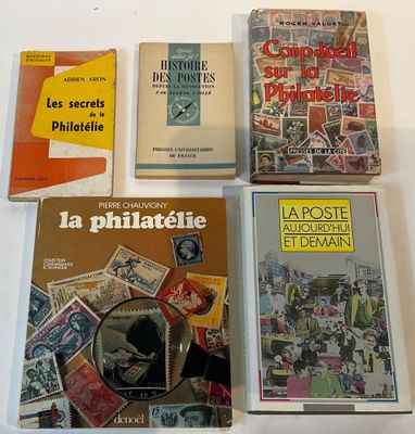 several books are sitting on a table with a white table cloth
