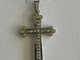 silver cross with clear stones on a white background with a price tag