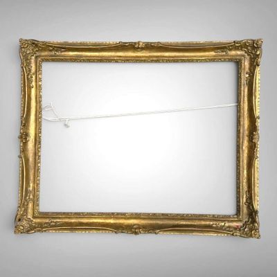 an old gold picture frame with a string attached to it