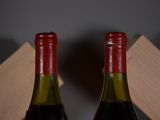 two bottles of wine sitting next to each other on a table