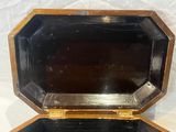 a small wooden box with a mirror inside of it