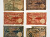 six old french bank notes are displayed on a white surface