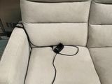 two reclining chairs with a power headrest and a remote control